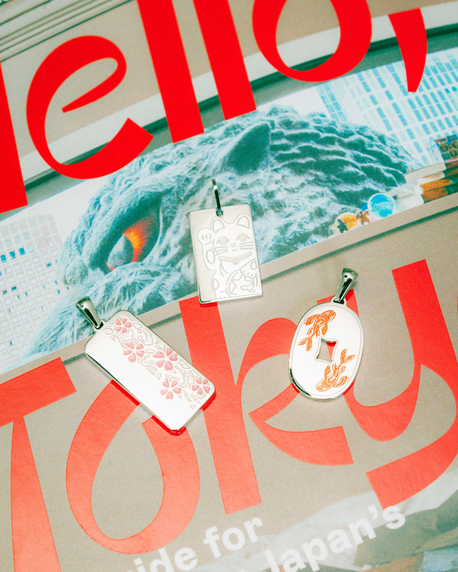 Flat lay with the Sakura, Lucky Cat and Koi Fish pendants