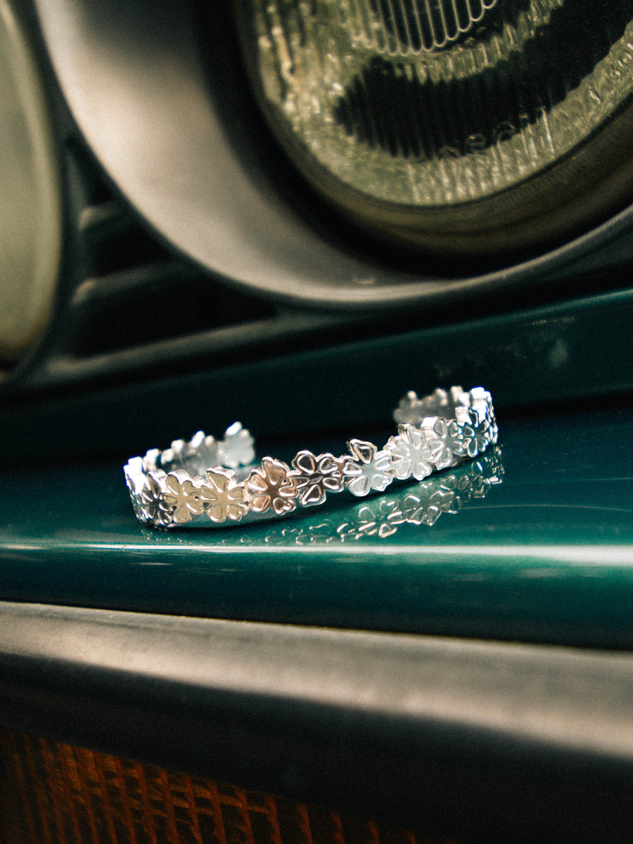 Petal Cuff resting on a car body